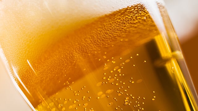 beer glass close up with froth smaller